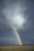 Optical wonder, with a rainbow arcing from a turbulent cloud