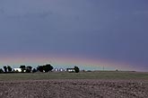 Very low rainbow over farm