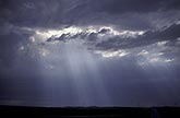 Sunlight breaks through clouds as soft crepuscular rays