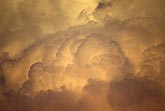 Billowing clouds glow gold in a heavenly sky