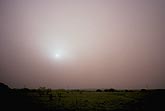 Thick blowing dust shrouds the sun and brings to mind dust bowl days