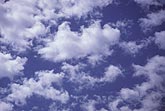 Random arrangement of white clouds on blue sky