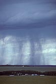 Sinuous rain shafts fall from a stormy sky