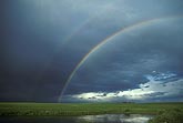 A double rainbow where sunshine strikes raindrops