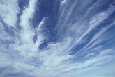 A fan of Cirrus clouds spreading across a bright blue sky