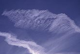 Close-up showing intricate detail in two contrails (jet trails)