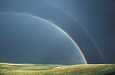 Double rainbow in a black stormy sky