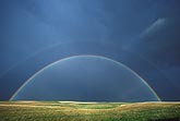 A full double rainbow shines hope on green pastures