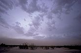 A threatening wall of dust below a desert storm