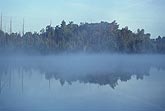 Thin fog and mist on a lake with reflections