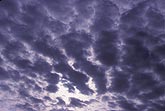 Cloud billows fan out across a brooding sky
