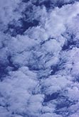 Puffs of cloud in bright blue abstract skyscape