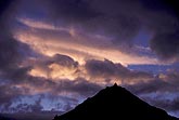 Sunset bathes a mountain cloudscape in enchantment and mystery