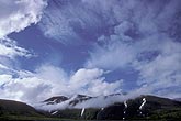 Many different types of clouds at all levels in a mountain skyscape
