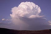 An isolated, high-based thunderhead with rain