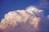 A dense Pileus cap cloud above the rolling tops of a storm