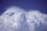 A double layer of Pileus clouds across two towers above a storm