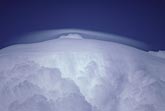 Thin, new Pileus cloud compressed by the flow above