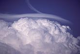 A dense, detached Pileus cap cloud above a storm