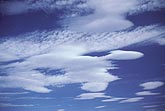 Dreamy smooth lenticular clouds sweep across the sky