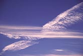 Jet condensation trails (man-made clouds) criss-cross the sky, 
